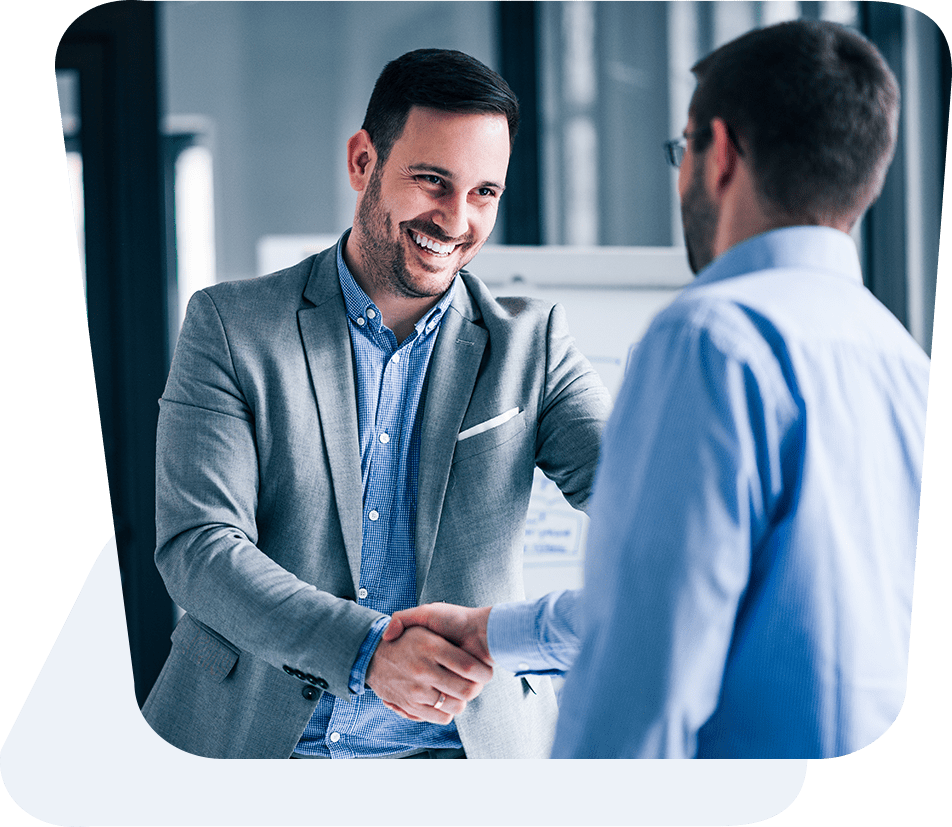 Professional business meeting with two businessmen shaking hands in a modern office environment
